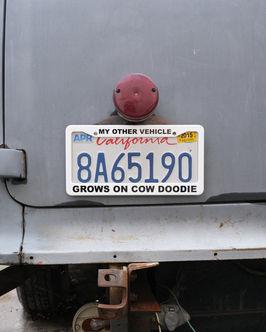 License Plate Frame 3: Cow Doodie